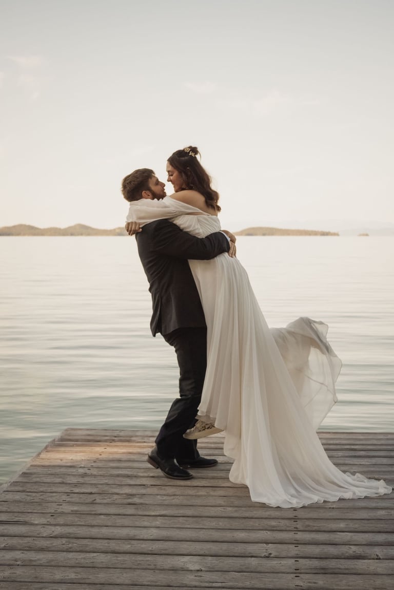bride and groom portrait, groom picking bride up, dock on Flathead Lake