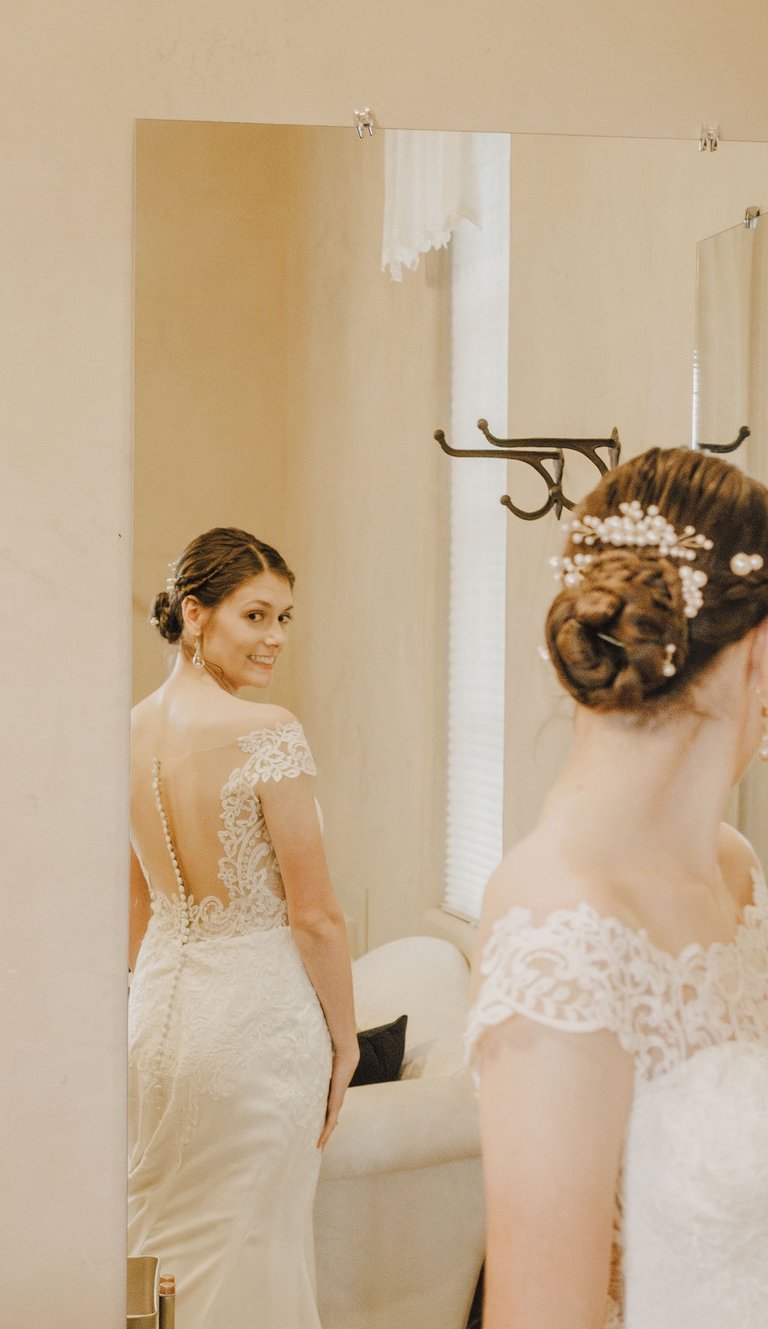 bridal portrait, bride looking at herself in the mirror