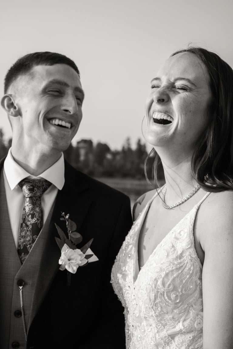 candid black and white bride and groom portrait, laughing