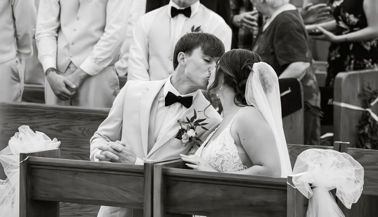 Catholic wedding ceremony first kiss, kneeling, black and white