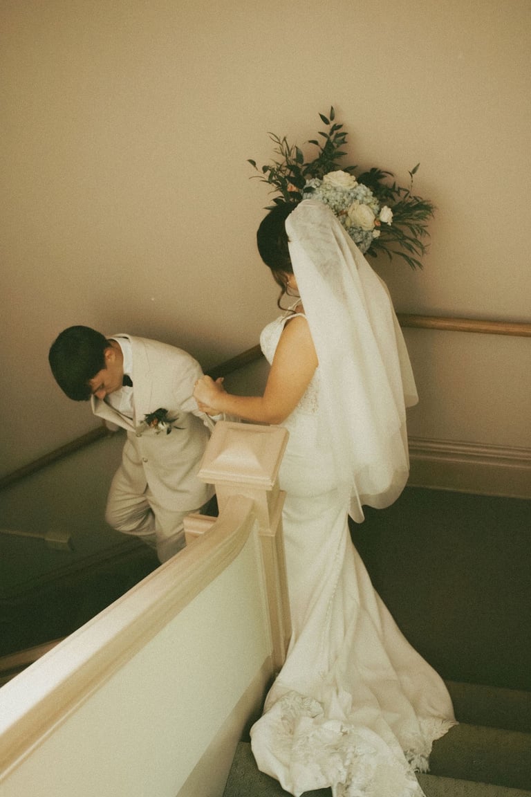 bride and groom portrait, groom leading bride down stairs
