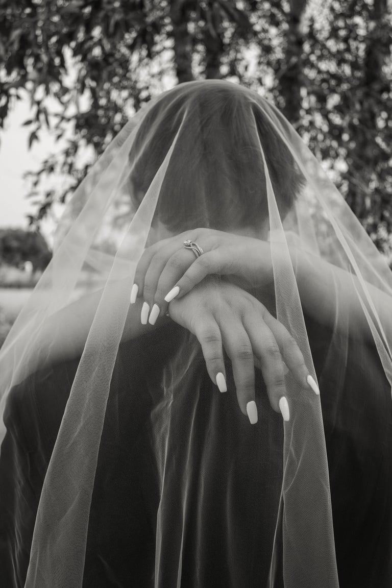 black and white detail shot of bride's nails, ring, under the veil shot
