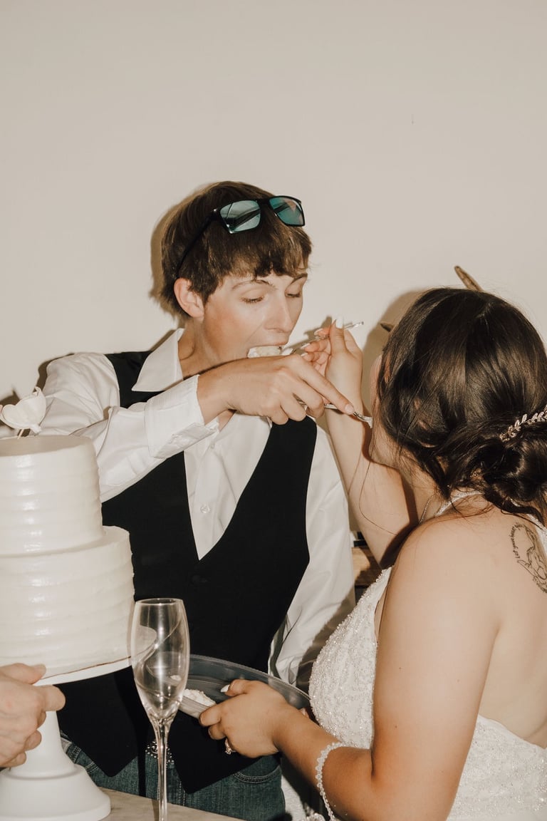 bride and groom cake cutting, feeding each other cake
