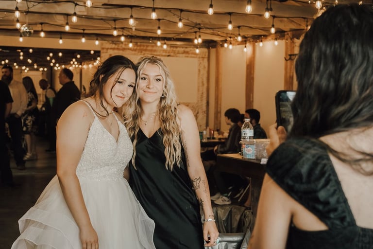 bride taking a photo with a guest at reception