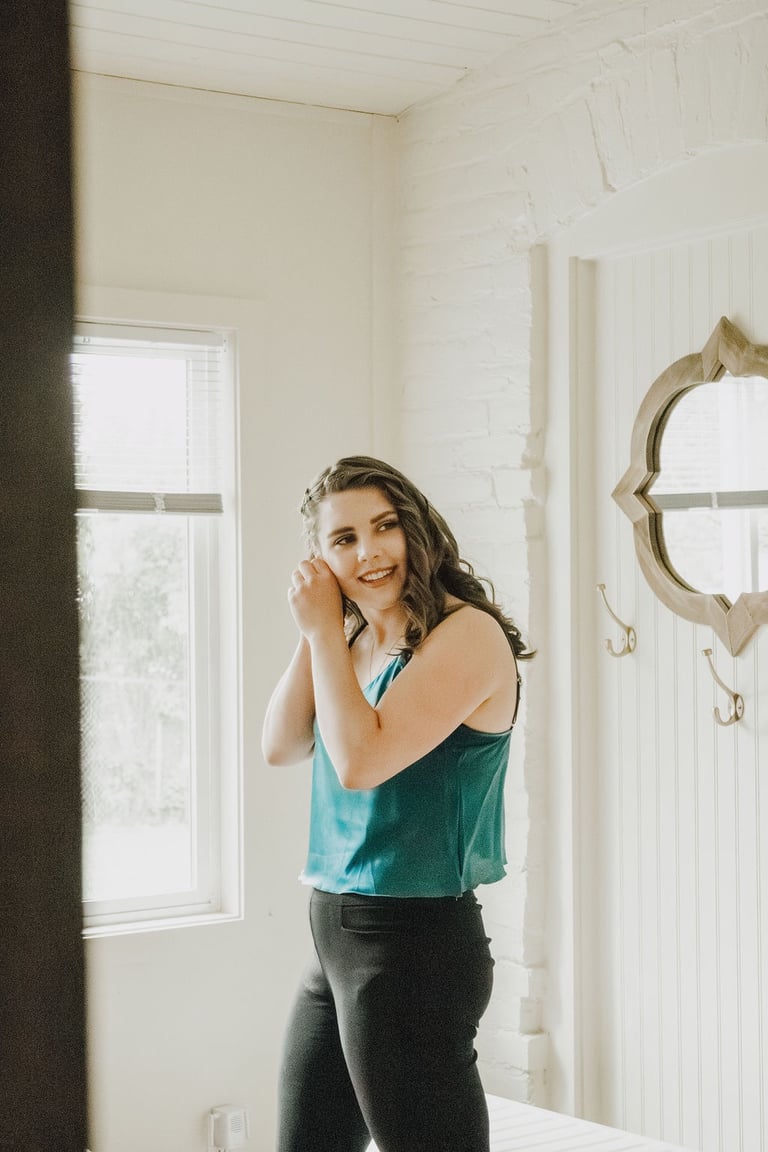 bridesmaid getting ready, putting on earrings, Snowline Acres
