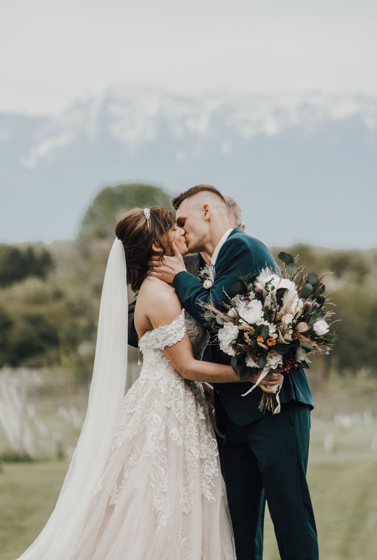 bride and groom share first kiss after ceremony, Kalispell mountains