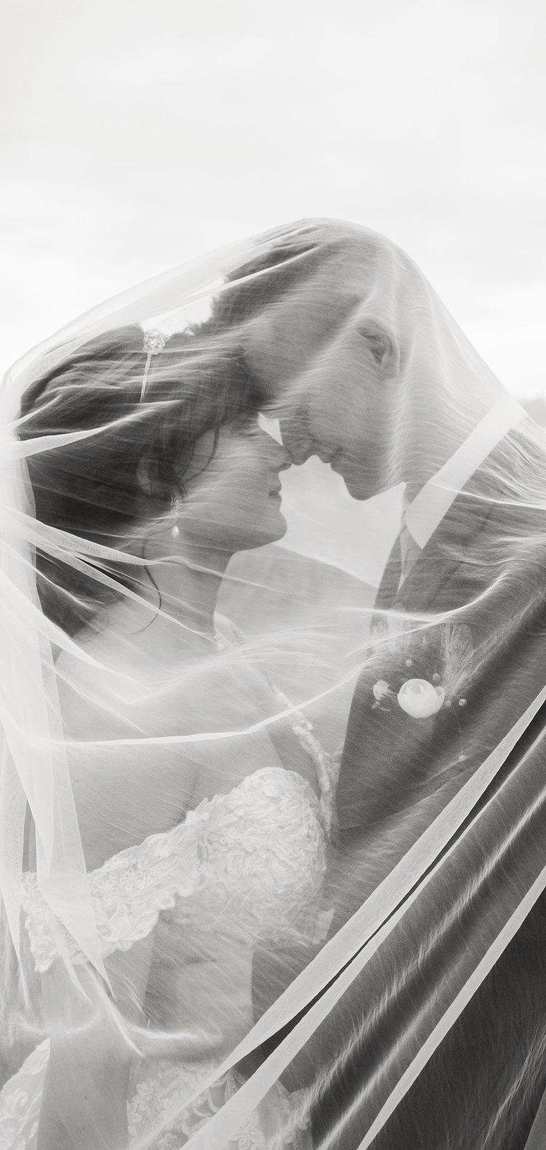 black and white bride and groom portrait, under the veil shot