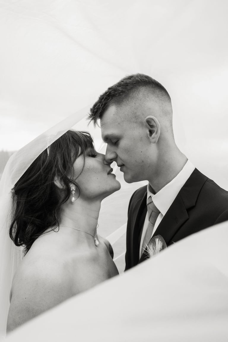 black and white bride and groom portrait, under the veil shot