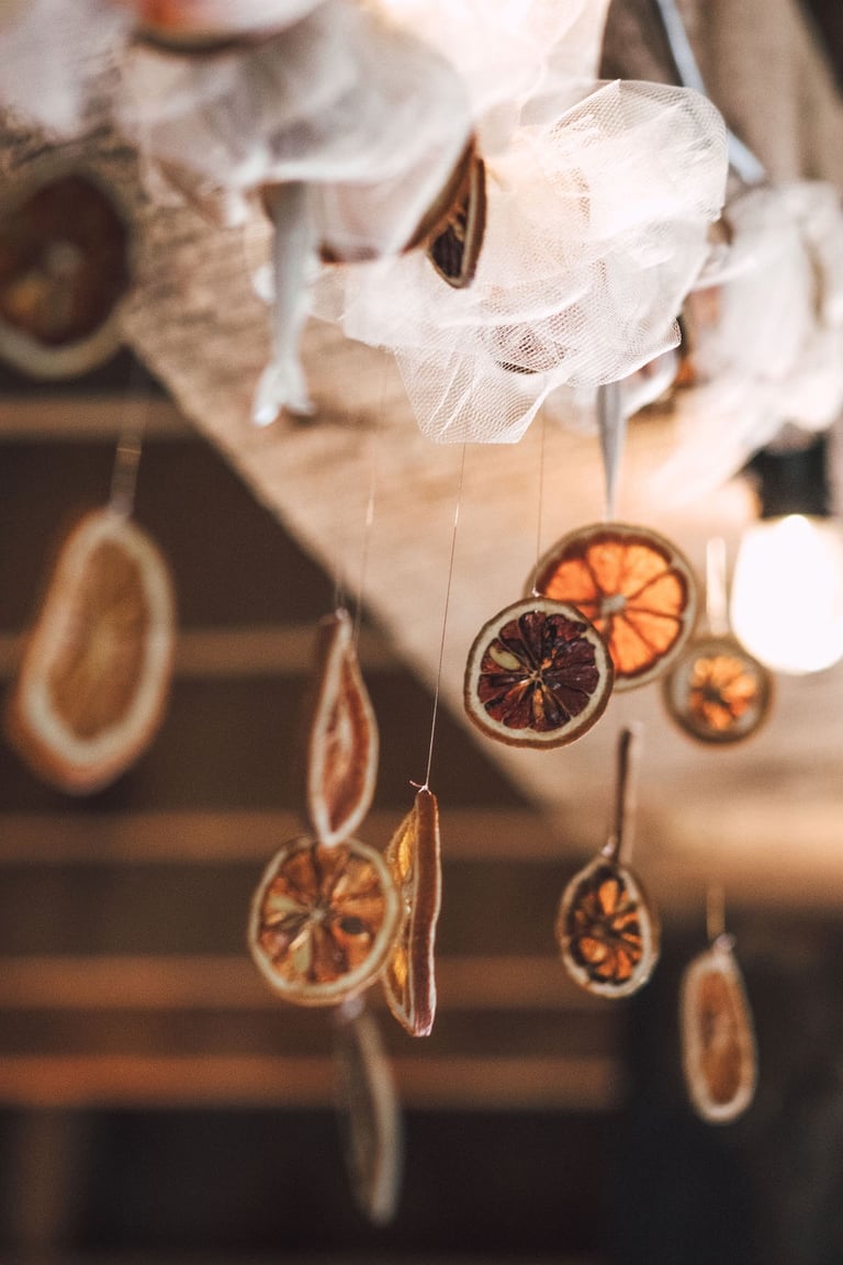 dried oranges hanging from wooden beam, reception details