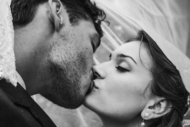 black and white photo, bride and groom portrait, under the veil shot