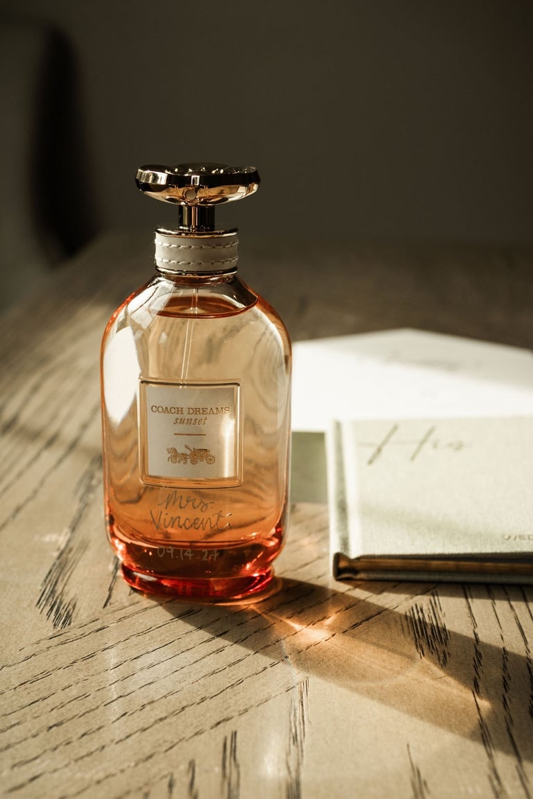 detail shot of perfume, vows, and invite