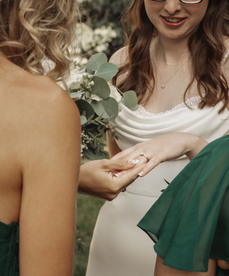 bridesmaids looking at bride's ring
