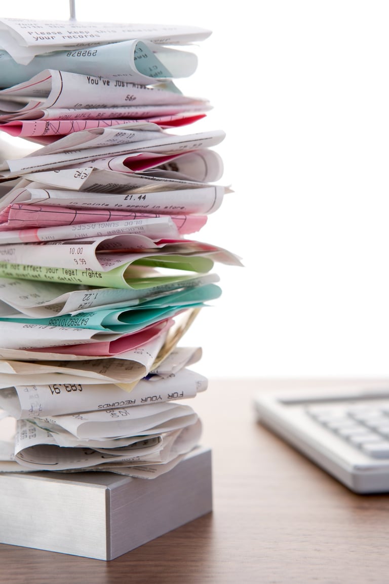A messy stack of receipts needing cleaning up