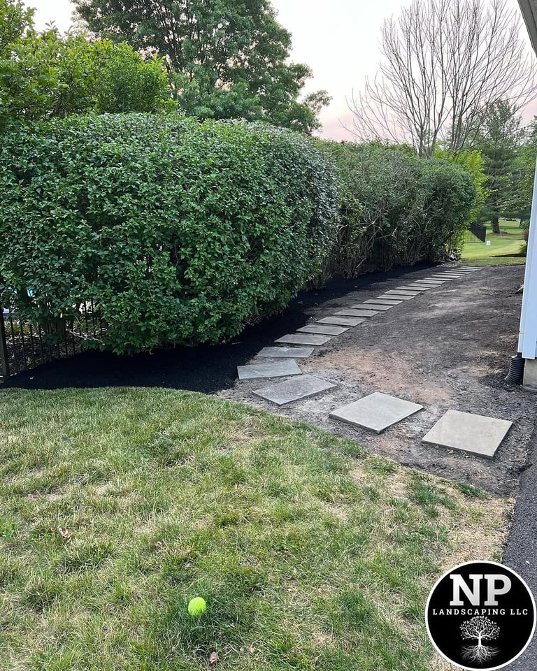 excellent landscaping and hardscaping of grass, stones and trees by NP Landscaping