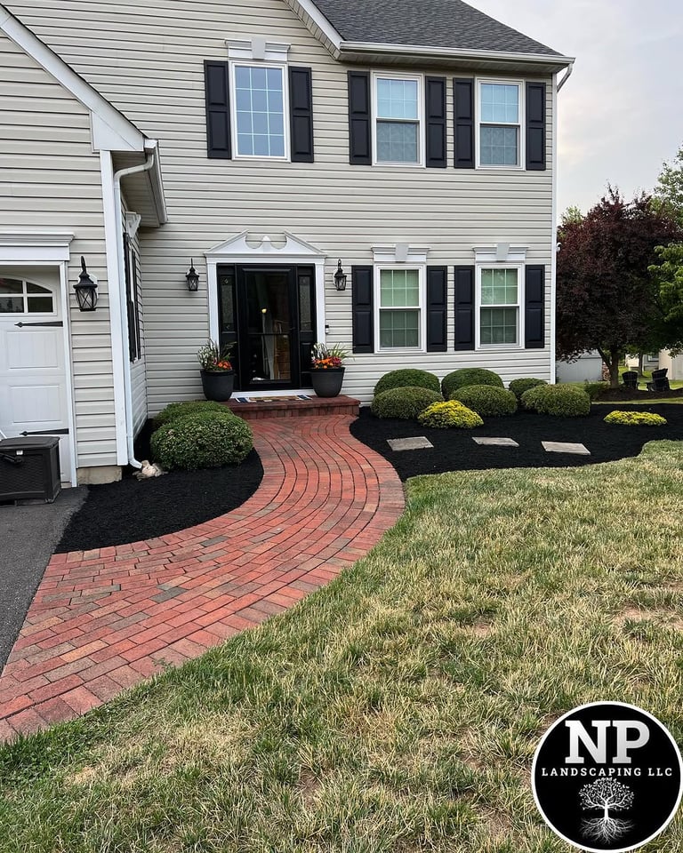 excellent landscaping and hardscaping of grass, stones and trees by NP Landscaping