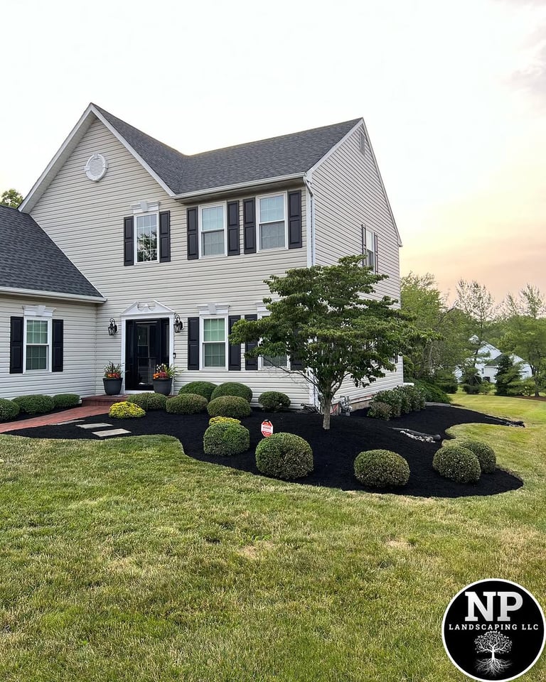 excellent landscaping and hardscaping of grass, stones and trees by NP Landscaping