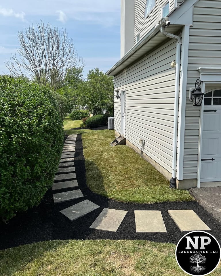 excellent landscaping and hardscaping of grass, stones and trees by NP Landscaping