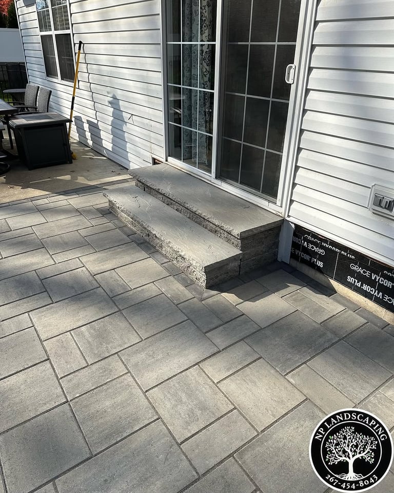 excellent landscaping and hardscaping of grass, stones and trees by NP Landscaping