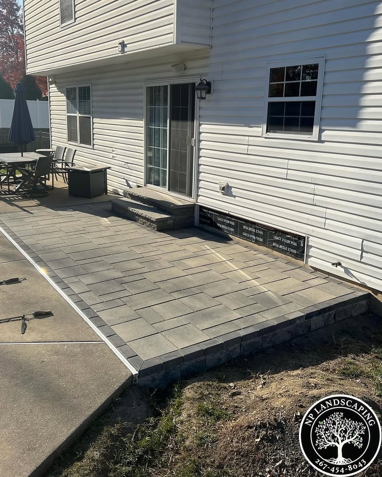 excellent landscaping and hardscaping of grass, stones and trees by NP Landscaping