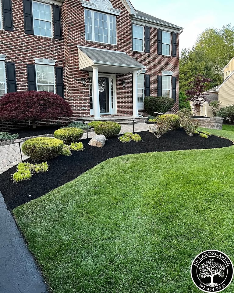 excellent landscaping and hardscaping of grass, stones and trees by NP Landscaping