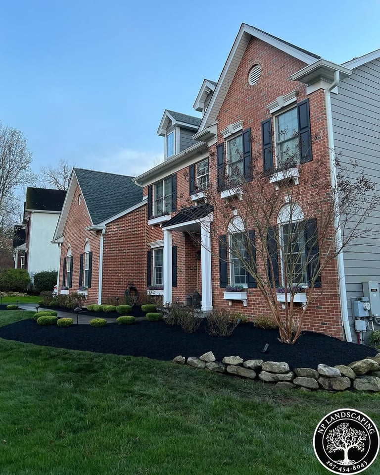 excellent landscaping and hardscaping of grass, stones and trees by NP Landscaping