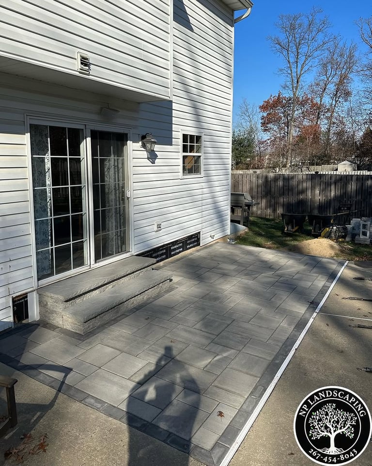 excellent landscaping and hardscaping of grass, stones and trees by NP Landscaping