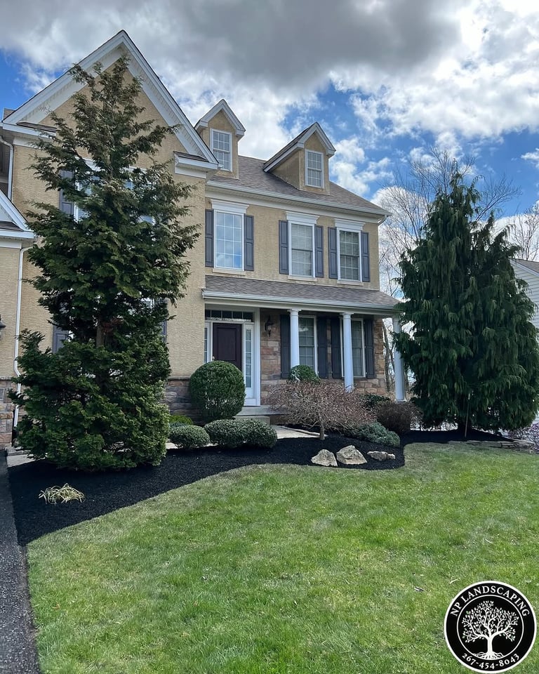 excellent landscaping and hardscaping of grass, stones and trees by NP Landscaping