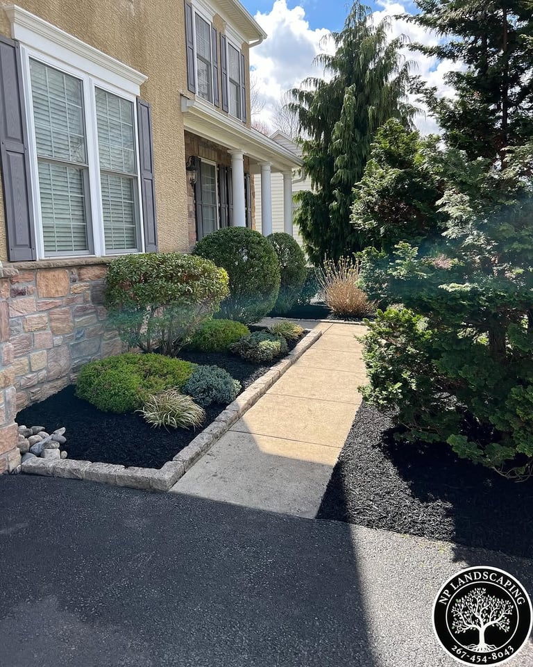 excellent landscaping and hardscaping of grass, stones and trees by NP Landscaping