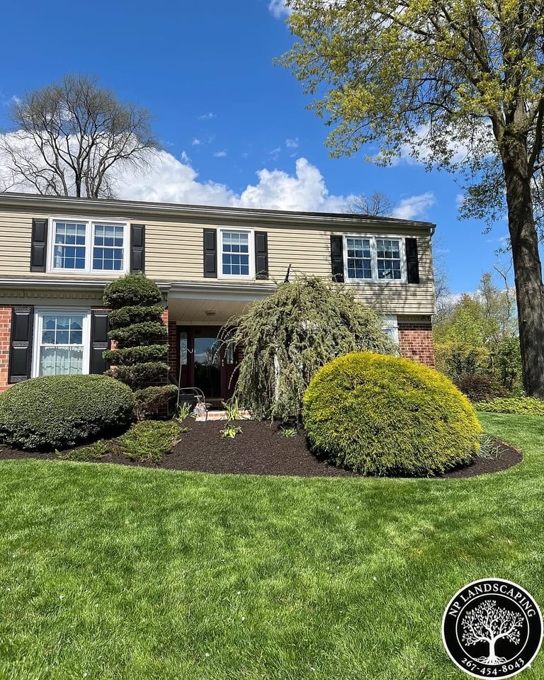 excellent landscaping and hardscaping of grass, stones and trees by NP Landscaping