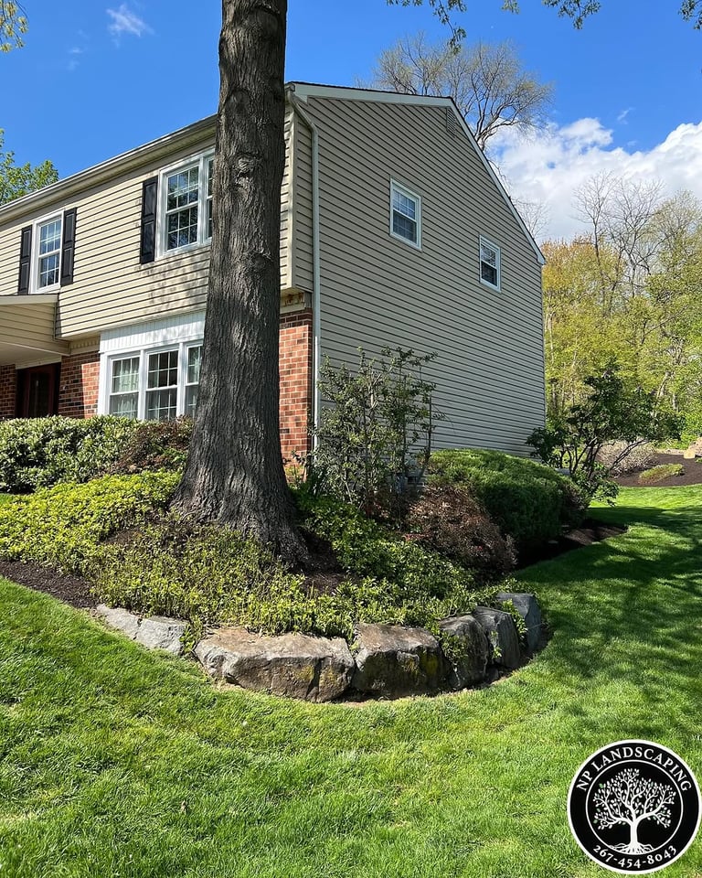 excellent landscaping and hardscaping of grass, stones and trees by NP Landscaping