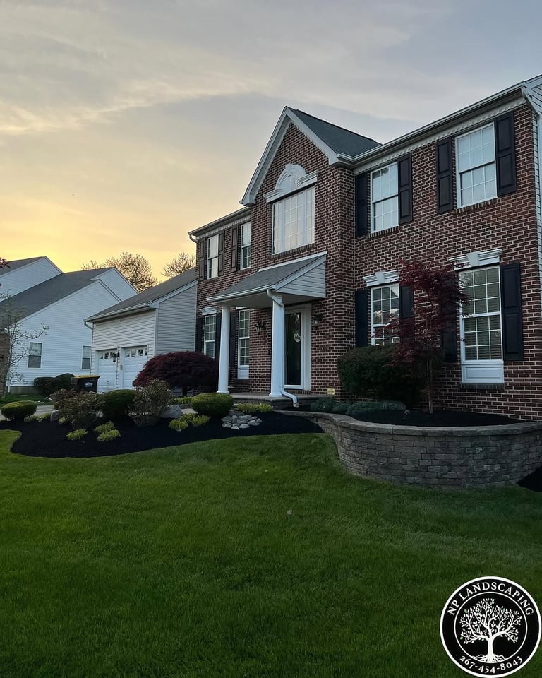 excellent landscaping and hardscaping of grass, stones and trees by NP Landscaping