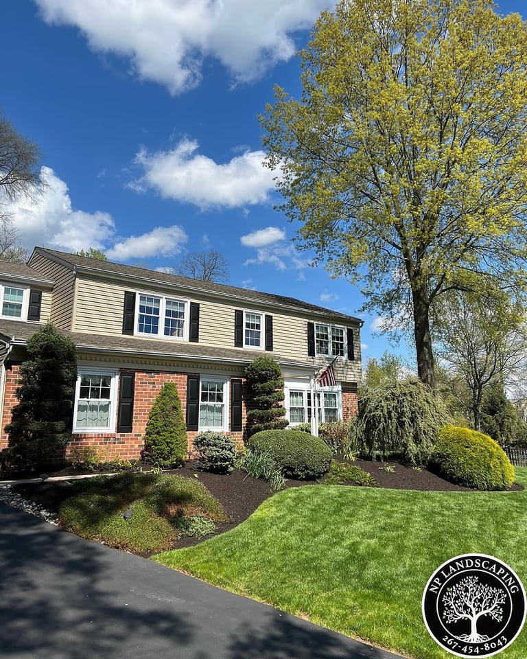 excellent landscaping and hardscaping of grass, stones and trees by NP Landscaping