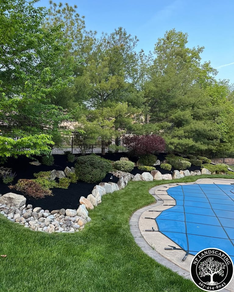 excellent landscaping and hardscaping of grass, stones and trees by NP Landscaping