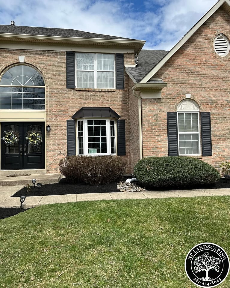 excellent landscaping and hardscaping of grass, stones and trees by NP Landscaping