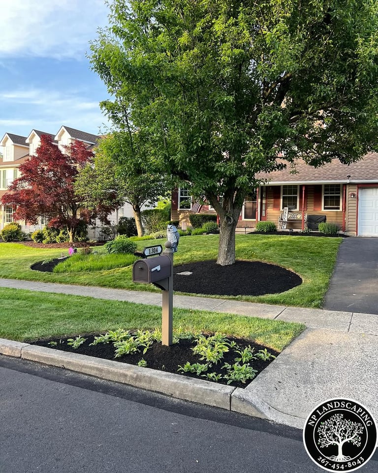 excellent landscaping and hardscaping of grass, stones and trees by NP Landscaping