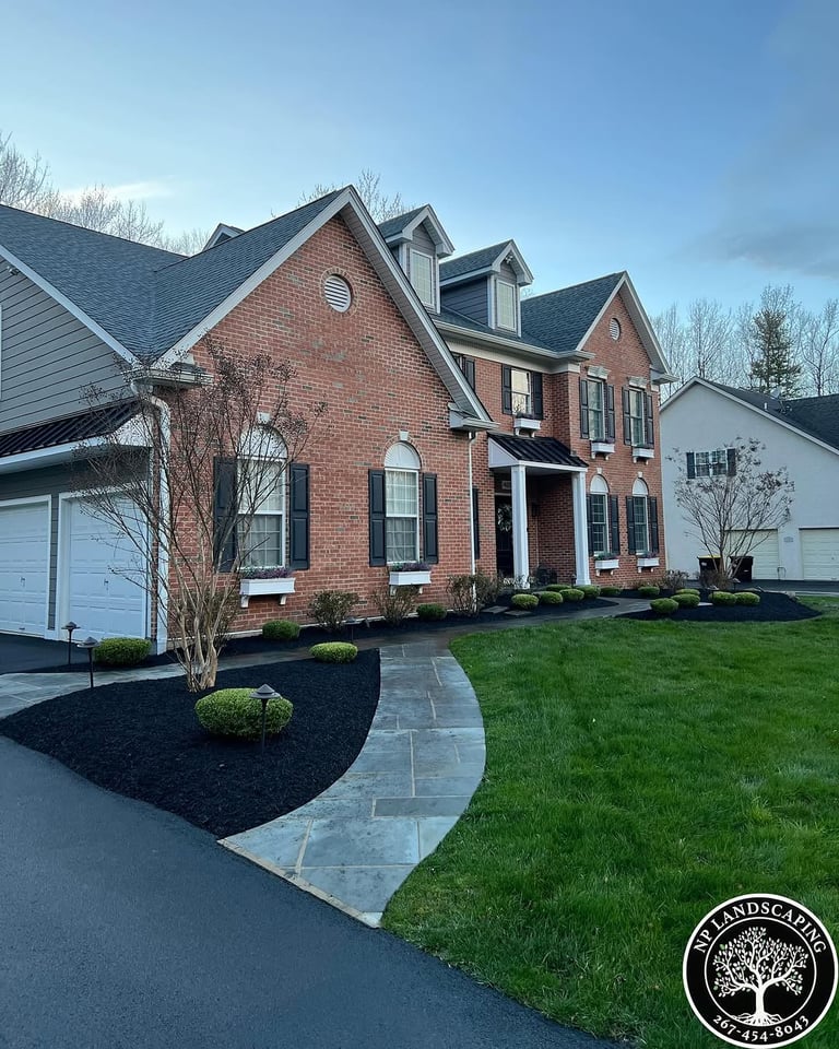 excellent landscaping and hardscaping of grass, stones and trees by NP Landscaping