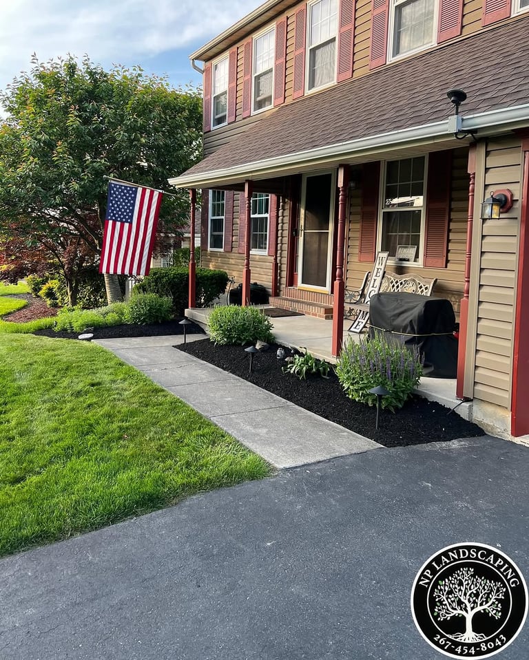 excellent landscaping and hardscaping of grass, stones and trees by NP Landscaping