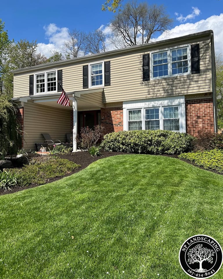 excellent landscaping and hardscaping of grass, stones and trees by NP Landscaping