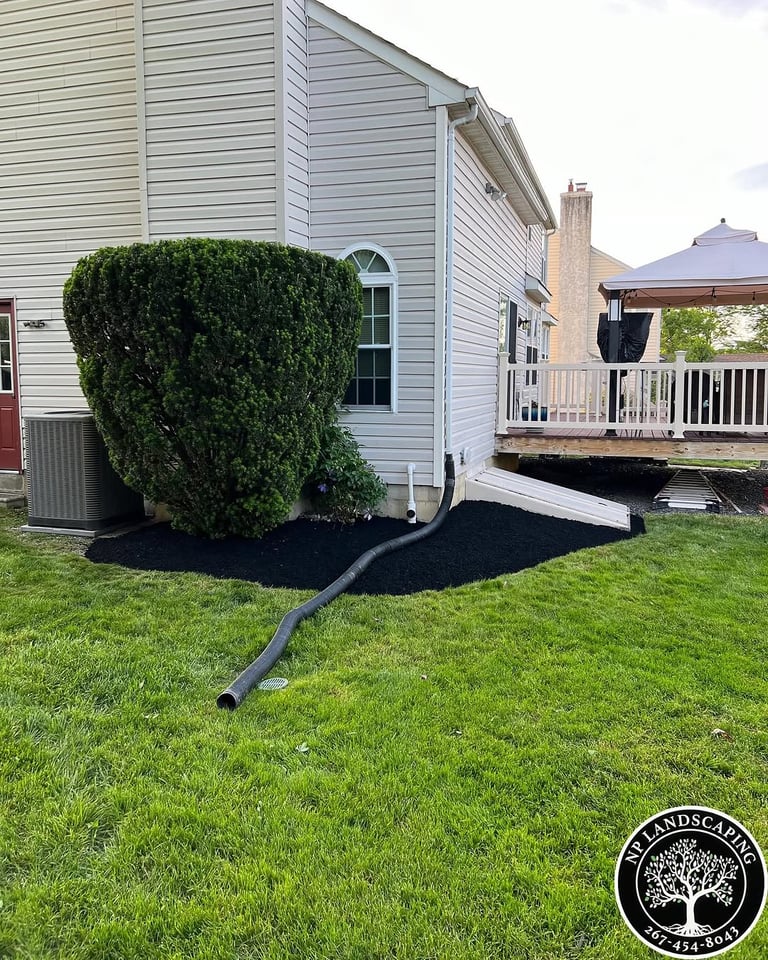 excellent landscaping and hardscaping of grass, stones and trees by NP Landscaping