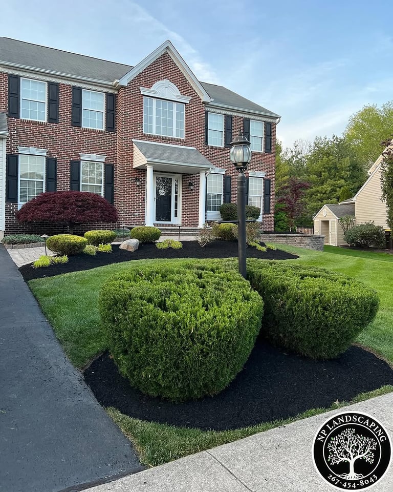 excellent landscaping and hardscaping of grass, stones and trees by NP Landscaping