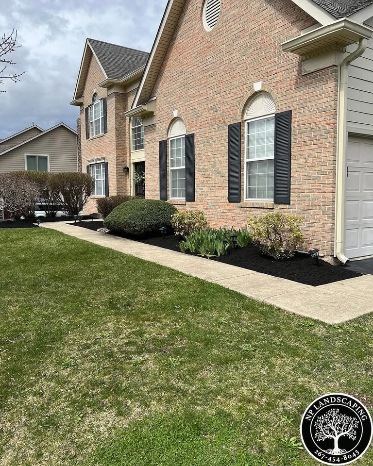 excellent landscaping and hardscaping of grass, stones and trees by NP Landscaping