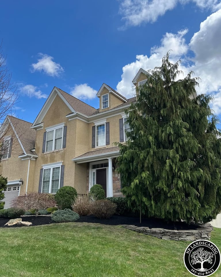 excellent landscaping and hardscaping of grass, stones and trees by NP Landscaping