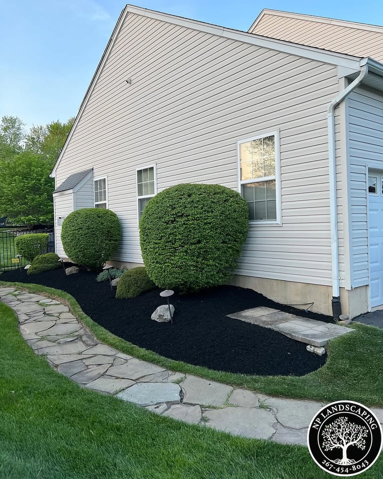 excellent landscaping and hardscaping of grass, stones and trees by NP Landscaping