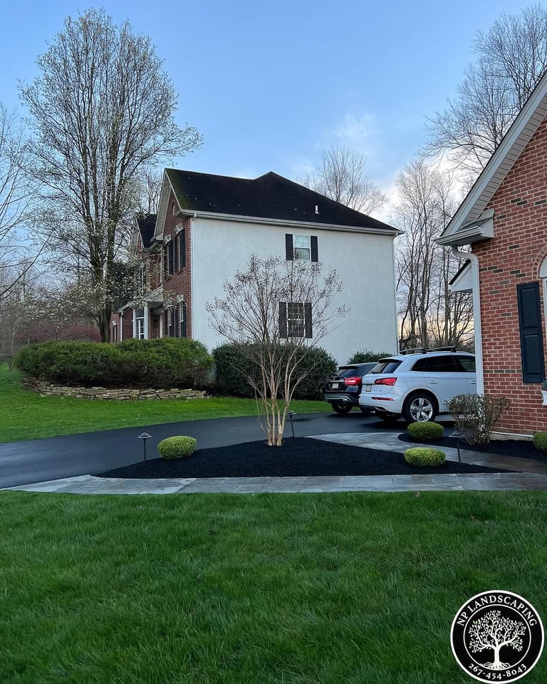 excellent landscaping and hardscaping of grass, stones and trees by NP Landscaping