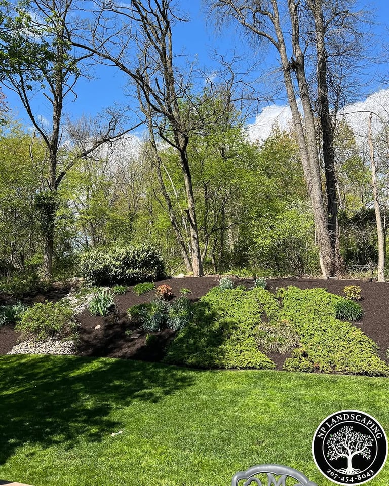 excellent landscaping and hardscaping of grass, stones and trees by NP Landscaping