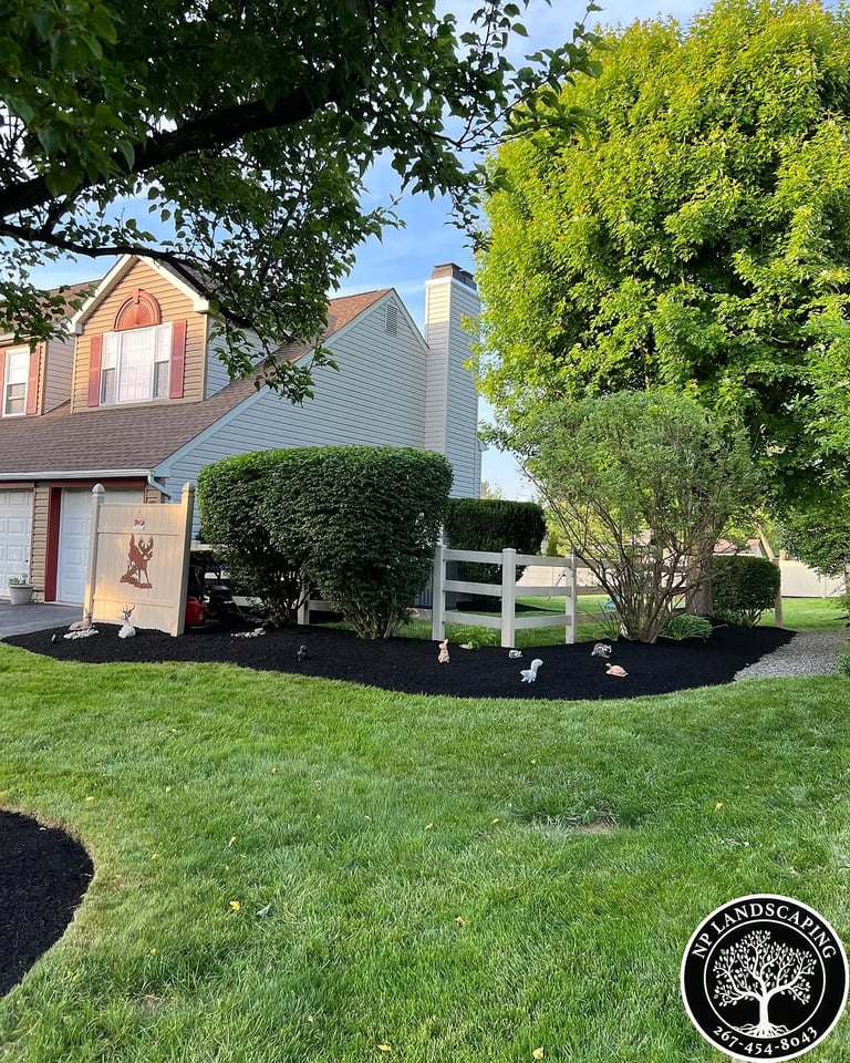 excellent landscaping and hardscaping of grass, stones and trees by NP Landscaping