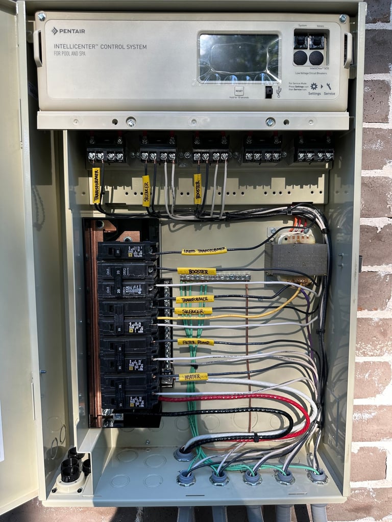 Pentair IntelliCenter pool and spa control system panel with labeled circuit breakers and wiring.