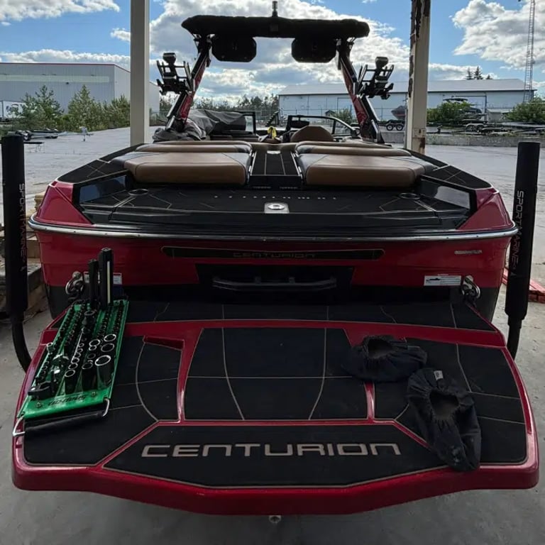Centurion wake boat on lift at Ontario marina - wake and surf performance service by STO Boats