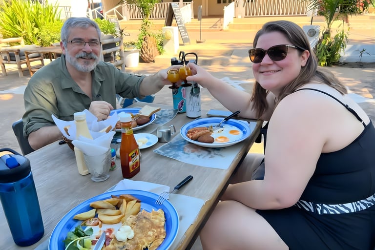 Stephanie and her father enjoy breakfast at a resort patio.