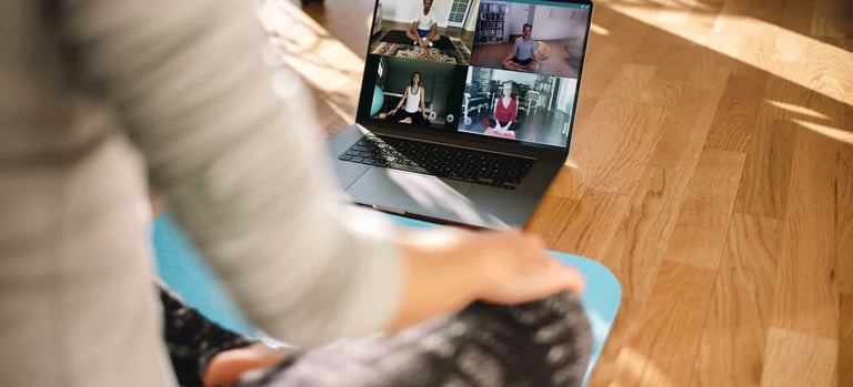 a laptop screen showing a yoga and meditation class